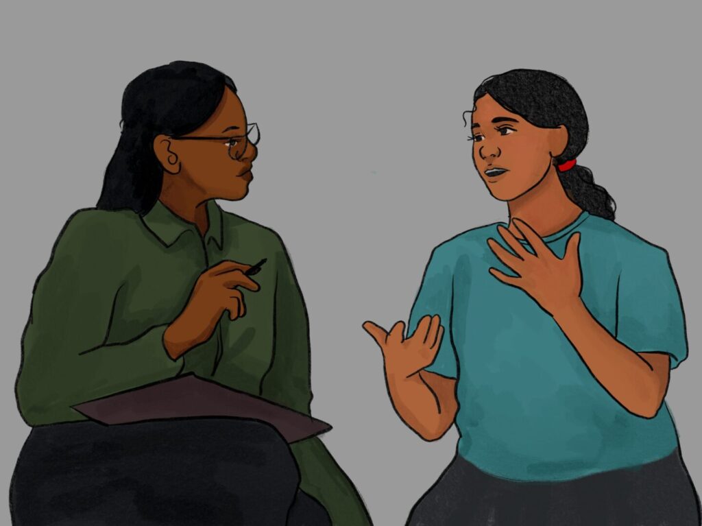 Two individuals are sitting and yarning. One, a concerned parent seeks help while the other, a support service professional, is listening.